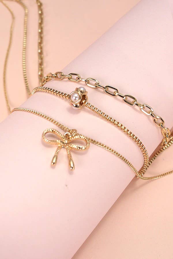 MULTI LAYER PEARL BOW CAHRM NECKLACE