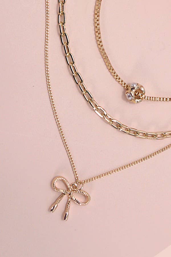 MULTI LAYER PEARL BOW CAHRM NECKLACE